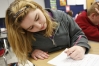 Eighth-grade student Tiffany Beam takes notes for her group in cursive during Susan Hey\'s social studies class at Bloomfield Middle School (Nelson County).Photo by Amy Wallot, March 15, 2013