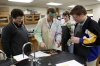 Kentucky High School Teacher of the Year Joshua Underwood gives a piece of sodium to junior Justin Conrad, sophomore Braiden Hickman and junior Peter Maurer to perform an experiment on looking for signs of a chemical reaction. Photo by Amy Wallot, Jan. 9, 2015