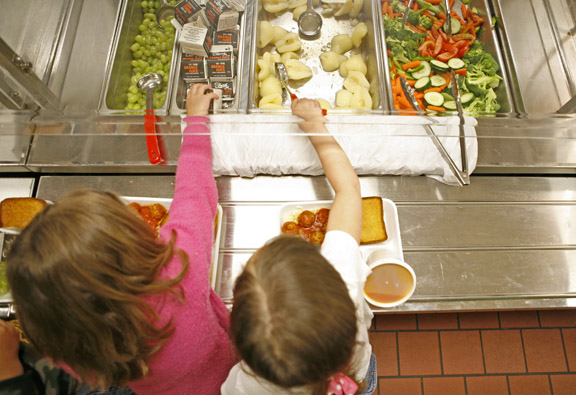 Students at John W. Miles Elementary School (Erlanger-Elsmere Independent) select from fruits and vegetables during lunch April 26, 2010. Eligible elementary schools may receive funding through grants for the Fresh Fruit and Vegetable Program. File photo by Amy Wallot