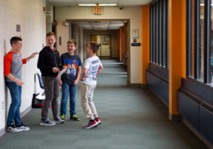 A group of students jokes in hallway in-between classes at Gray Middle School (Boone). Photo by Bobby Ellis, Jan. 24, 2017