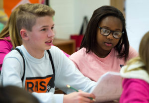 Cole Sullivan, left, and Sarai Culton take notes during Pam Ollier's 8th-grade math class at Gray Middle School (Boone). Photo by Bobby Ellis, Jan. 24, 2017