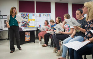 Kellie Clark, a choral teacher at Randall K. Cooper High School, goes over a piece of music with her students during class. Clark was named the 2018 Kentucky Teacher of the Year. Photo by Bobby Ellis, April 21, 2017