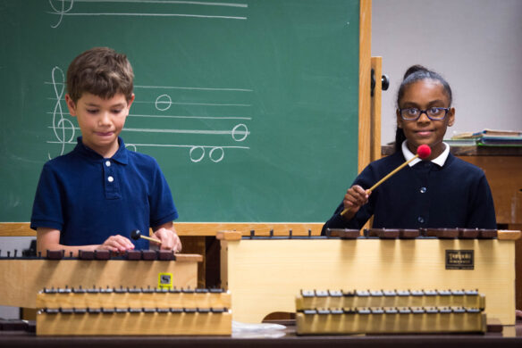 Two kids play xylophones