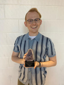 Zach Neal poses with a geode