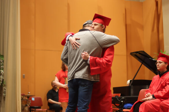 A student hugs his father