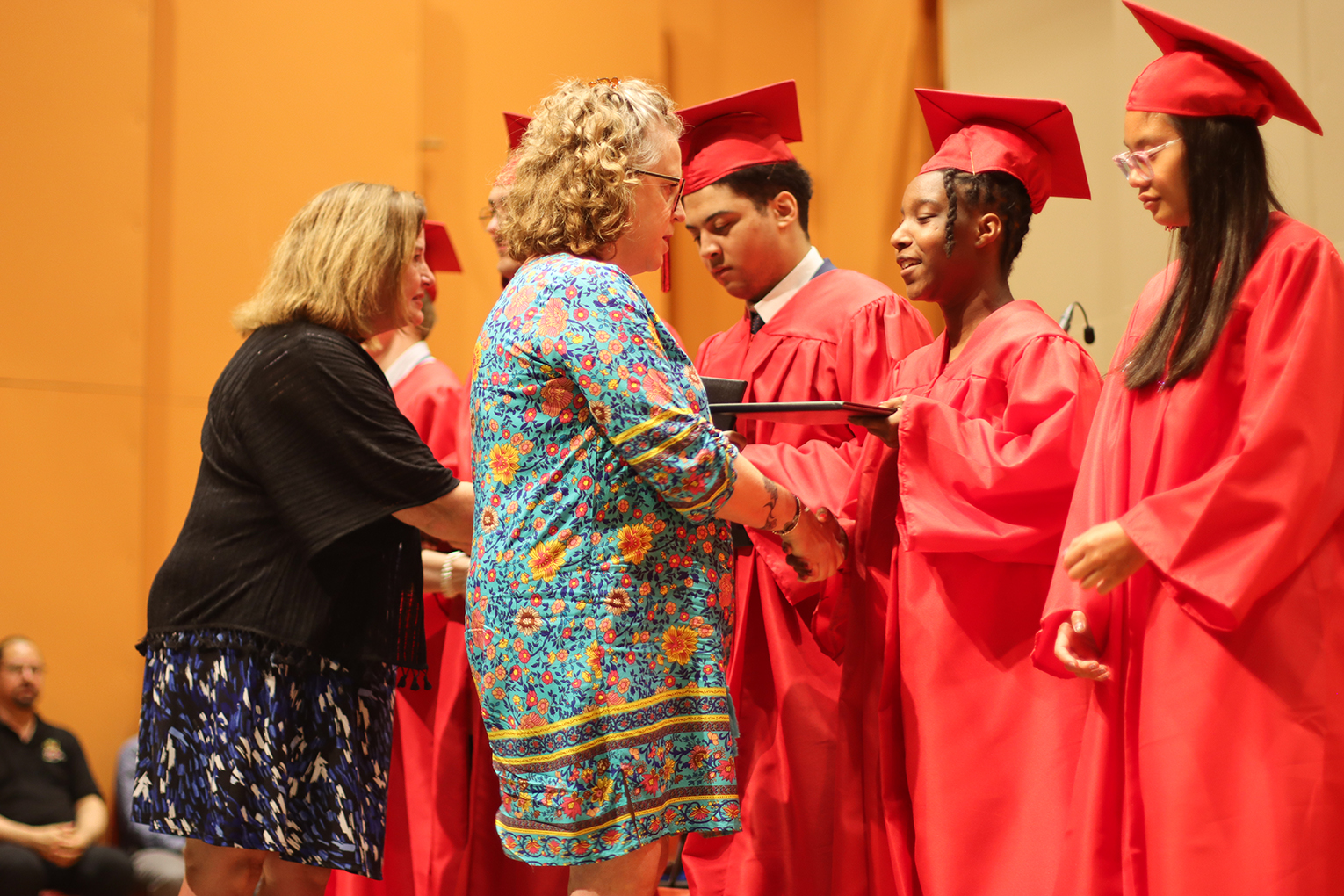 Peggy Sinclair-Morris and Robin Fields Kinney give diplomas to the Kentucky School for the Blind's 2024 graduating class
