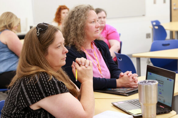 Two teachers sit at a table