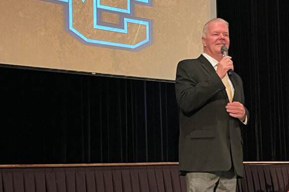 Bill Thorpe speaks into a microphone while standing on a stage