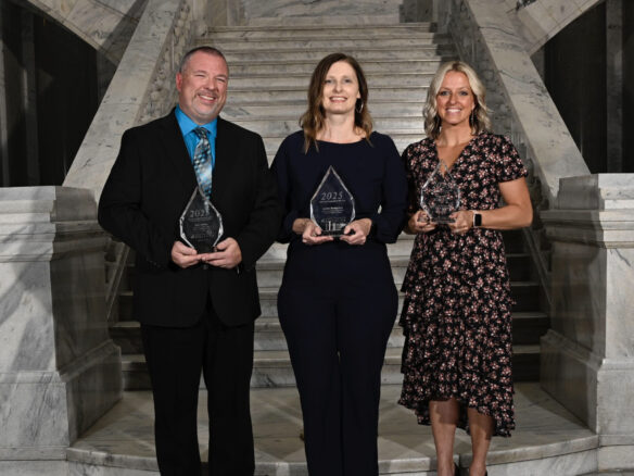 Scott Johnson, Jennifer Montgomery and Hayley Dant pose for a photo with their Teacher of the Year awards