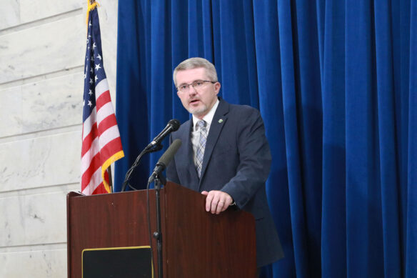 Robbie Fletcher speaks at a podium.