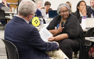 Penny Christian speaks into a microphone