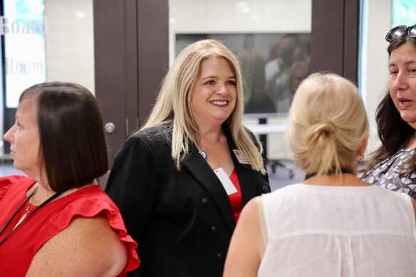 Wendy Duvall stands in a crowd of others