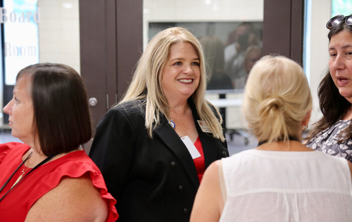 Wendy Duvall stands in a crowd of others