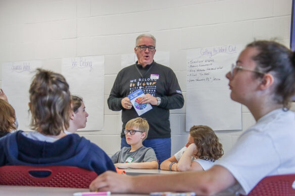 Doug Roberts stands up in a room, talking to students.